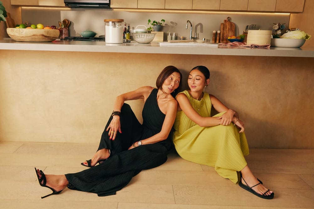 From Left to Right Gym Tan in Simone Pleated Padded Twist Back Jumpsuit (Black) Mya Miller in Dez Pleated Boat Neck Crop Top (Dusty Citron) and Gym Pleated Column Midi Skirt (Dusty Citron)